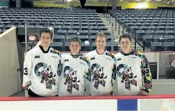  ?? SUBMITTED PHOTO ?? Members of the Niagara IceDogs model jerseys with the autism awareness logo, being auctioned off Saturday.