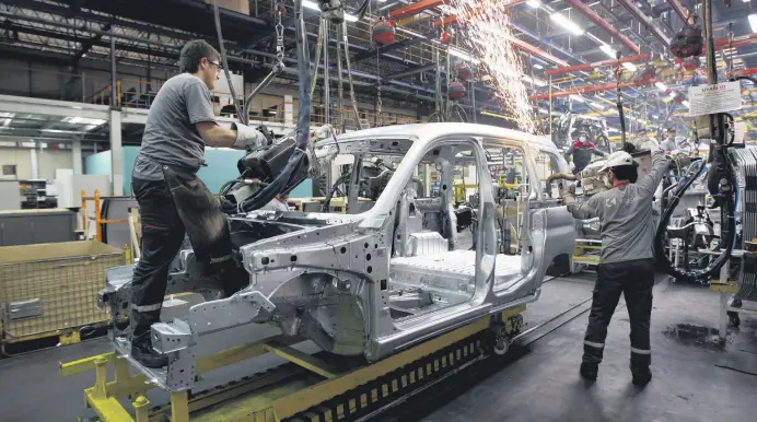  ??  ?? Employees work on the assembly line of the Karsan automotive factory in Bursa, Turkey.