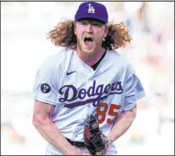  ?? Alex Gallardo The Associated Press ?? Dodgers starter Dustin May exults after striking out Nick Fortes with the bases loaded to end the top of the first inning of Los Angeles’ win over Miami on Saturday at Chavez Ravine.