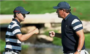  ??  ?? Good job: Kevin Kisner (left) and Phil Mickelson of the US Team celebratin­g on the first green after going one-up during the foursome matches of the Presidents Cup on Thursday. — AFP