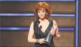  ?? Al Wagner / Associated Press ?? Reba McEntire accepts the Artist of a Lifetime award at 2019 CMT Artists of the Year at Schermerho­rn Symphony Center in Nashville, Tenn.