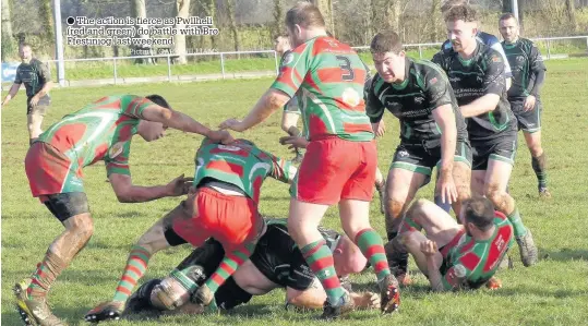  ?? Picture: GARY WILLIAMS ?? ● The action is fierce as Pwllheli (red and green) do battle with Bro Ffestiniog last weekend