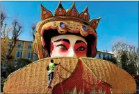  ?? ANGERER ERIC GAILLARD / REUTERS ?? A worker puts the final touches on Feb 8 on a work of art made with lemons and oranges, named “Beijing Opera”, in Menton, France. The artwork is part of the 89th Lemon Festival, whose theme this year is “Rock and Opera”.