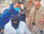  ?? HT ?? Gangster Papla (face covered) in Jaipur police custody.