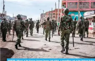  ??  ?? NAIROBI: Officers of the Kenyan General Service Unit (GSU), a paramilita­ry unit of the National Police Service of Kenya, patrol in the streets of the Kawangware slum in Nairobi yesterday. —AFP