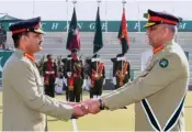  ?? AP ?? Pakistan’s outgoing Army Chief Gen. Qamar Javed Bajwa hands over a ceremonial baton to his successor Gen. Asim Munir during the Change of Command ceremony, in Rawalpindi, Pakistan, on Tuesday.