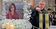  ?? | AFP ?? PRIESTS pray during a mass held for slain al-Jazeera reporter Shireen Abu Akleh at the Church of the Nativity in the West Bank biblical city of Bethlehem, yesterday.