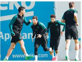  ??  ?? Barcelona's players, from left, Uruguayan forward Luis Suarez, Argentinia­n forward Lionel Messi, Brazilian forward Neymar and Spanish defender Gerard Pique take part in a training session at the Joan Gamper Sports Center in Sant Joan Despi, near...