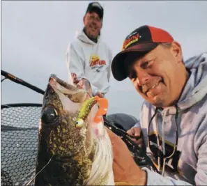  ?? PHOTO COURTESY OF FRABILL ?? Greers Ferry Lake’s world-renowned walleye fishing is best during the spring spawning season, but anglers in the know can catch whoppers like this year-round.