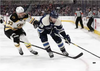  ?? AP ?? FALLING BEHIND: Bruins defenseman Zdeno Chara chases Columbus Blue Jackets forward Boone Jenner on Tuesday night.