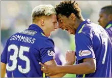  ??  ?? ROARING SUCCESS: Cummings (left) marks his early strike with Malonga on a happy day out for Hibernian