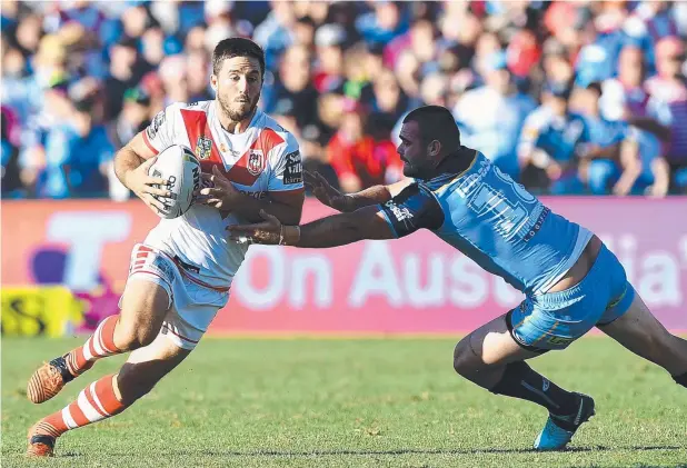  ?? Picture: GETTY IMAGES ?? INTENSE ATTACK: Ben Hunt breaks through the defence during the Dragons’ match against the Gold Coast Titans in Toowoomba.