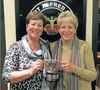  ??  ?? TAKING THE TROPHY: Shirley Heny, right, received the Atherstone Cup from lady president Sandy Fryer after winning last week’s ladies’ competitio­n at the Royal Port Alfred Golf Club