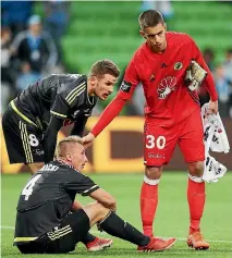  ?? MICHAEL DODGE ?? Wellington Phoenix goalkeeper Keegan Smith consoles a dejected Dario Vidosic, left, with Goran Paracki in the background after the 1-0 loss to Melbourne City on Saturday.