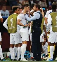  ?? AP/REBECCA BLACKWELL ?? England Coach Gareth Southgate (right) talks to John Stones during their team’s 2-1 World Cup semifinal loss to Croatia on Wednesday. England meets Belgium today in the third-place game.