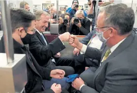  ?? Alex Brandon, The Associated Press ?? Michael van der Veen, lawyer for former President Donald Trump, second from left, bumps fists with someone as they ride on the Senate subway after the Senate acquitted Trump in Saturday’s impeachmen­t vote.