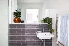  ??  ?? BATHROOMS
In the main bathroom (left) and ensuite (above left), Lucy was able to specify which tiles she wanted at the developer stage of the project. She opted for a simple but chic mix of plain white and grey Metro styles to help ensure a timeless look, enhanced by classic basins and taps from Villeroy & Boch