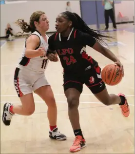  ?? Scott Herpst ?? LFO’s Christina Collins drives against a Signal Mountain player during a semifinal game at the Best of Preps Tournament at Chattanoog­a State this past Thursday. Collins scored 58 points in the three games, including 26 in the finals, as the Lady Warriors earned a second straight tourney title. Collins was the tournament’s MVP.