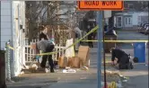  ?? JOHN BECHTOLD PHOTO ?? Law enforcemen­t personnel look for evidence after a shooting on Liberty Street in Kingston, N.Y., on Sunday, March 21.