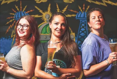  ?? Winter Caplanson/ CT Food & Farm photos ?? Mariah Billian, left, Abigail Bibens and Ryan Galligan are members of the Pink Boot Society, which works to support women in the brewing industry.