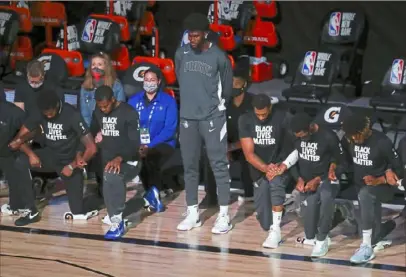  ?? Kim Klement/Associated Press ?? Orlando Magic forward Jonathan Isaac stands during the national anthem before the team’s NBA basketball game Sunday against the Sacrament Kings in Lake Buena Vista, Fla.