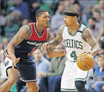  ?? [MICHAEL DWYER/THE ASSOCIATED PRESS] ?? Bradley Beal of the Washington Wizards, left, defends against the Boston Celtics’ Isaiah Thomas during the fourth quarter in Game 1 of their second-round playoff series Sunday in Boston. The Celtics won 123-111.