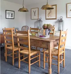  ??  ?? Below: The brass pendants above the dining table are from Jim Lawrence, and the table and chairs are from The Saleroom. Scottish artist Clare Brownlow, who paints using pheasant feathers, created the hare prints