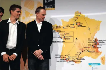  ?? Picture: REUTERS ?? THE ROAD AHEAD: 2017 Tour winner Chris Froome and Warren Barguil look at the map of the 2018 event in Paris yesterday.