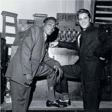  ??  ?? MEMPHIS BEATS Withers was 34 and had been working profession­ally for a decade when he took this photo of Presley with singer Brook Benton in Memphis in 1957. Like other black journalist­s, Withers was intent on presenting a true portrait of black life, like the rich music scene on Beale Street where Presley hung out. “In the eyes of the African-american press,” writes Lauterbach, “white media disseminat­ed demeaning stereotype­s of black people, diminished black achievemen­ts and highlighte­d black debauchery.” Opposite: The National Guard on Beale Street after the March 28, 1968, riot.