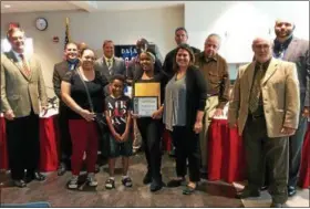 ?? CAROL HARPER — THE MORNING JOURNAL ?? Twelve-year-old Dyamond Henderson, center, a sixth-grade student from General Johnnie Wilson Middle School at 2700 Washington Ave. in Lorain, received a “Do the Right Thing” award from Lorain City Schools and Lorain Police Department for standing...