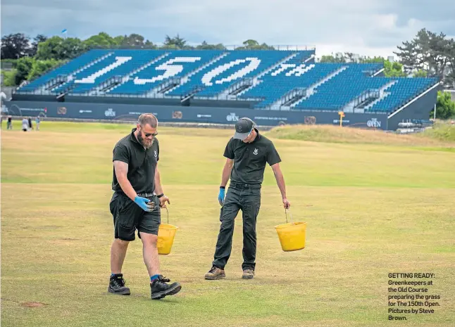  ?? ?? GETTING READY: Greenkeepe­rs at the Old Course preparing the grass for The 150th Open. Pictures by Steve Brown.