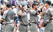 ?? ISAIAH J. DOWNING/USA TODAY SPORTS ?? Diamondbac­ks infielder Chris Owings (16) and teammates celebrate after defeating the Rockies on Thursday.