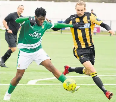  ?? Pictures: Paul Amos FM7821932, above; FM7821958, left ?? Above, Ashford’sBode Anidugbe stretches for the ball against East Grinstead.Left, Josh Wisson tries to hold off a challenge during Saturday’s game