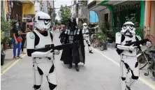  ?? AP ?? Youngsters in Star Wars costumes entertain residents in Metro Manila.