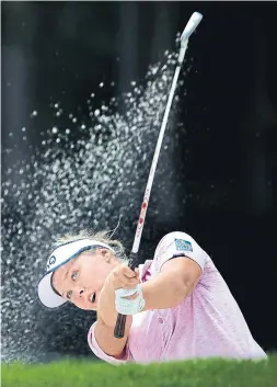  ?? CHRISTIAN PETERSEN/GETTY IMAGES ?? Brooke Henderson of Canada plays from the bunker on the second hole during the first round of the U.S. Women’s Open at Shoal Creek on Thursday.
