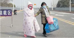  ??  ?? DANGEROUS JOURNEY: A leukaemia patient and her mother from Hubei province cross a checkpoint at Jiujiang Yangtze River Bridge in Jiangxi province on Friday.