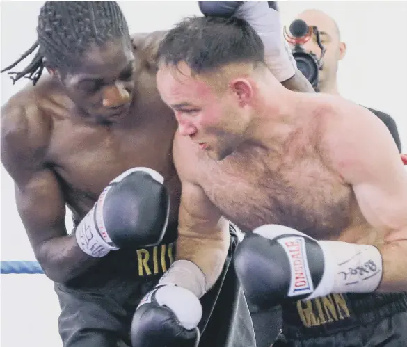  ??  ?? Glenn Foot battles in vain against challenger Akeem Brown in their exciting English light-welterweig­ht title. Pictures: Tom Banks