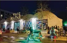  ?? TOM MCCARTHY JR. / FOR AMERICAN-STATESMAN ?? A handful of people linger outside Fair Market after what organizers called a “security threat” canceled Saturday evening’s South by Southwest performanc­e by the Roots and friends.