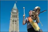  ?? CP PHOTO ADRIAN WYLD ?? Chief Marcia Brown Martel sings Friday outside the parliament buildings in Ottawa following the government announcing a compensati­on package for indigenous victims of the ’60s scoop.