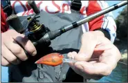  ?? NWA Democrat-Gazette/FLIP PUTTHOFF ?? A Skirmish A-10 crank bait is also used by Greg Bohannan to catch bass. He prefers red or green depending on water clarity.