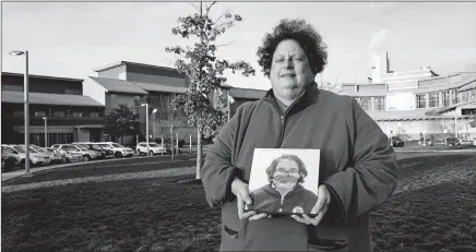  ?? CHARLES KRUPA/AP ?? Laura Dilts holds a photograph of her teenage son last month outside the Worcester Recovery Center, where he was getting mental health treatment.