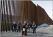  ?? GREGORY BULL — THE ASSOCIATED PRESS ?? U.S. Department of Homeland Security Secretary Kirstjen Nielsen, center, speaks in front of a newly fortified border wall structure Friday in Calexico