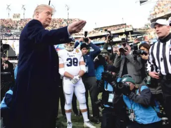  ?? AP ?? President Donald Trump prepares to conduct the coin toss at the Army-Navy game Saturday in Philadelph­ia.