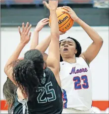  ??  ?? Moore High School's Aaliyah Moore (23) puts up a shot during during Tuesday night's girls game against Norman North. Moore had 28 points in the Lions' 54-47 win. [BRYAN TERRY/ THE OKLAHOMAN]