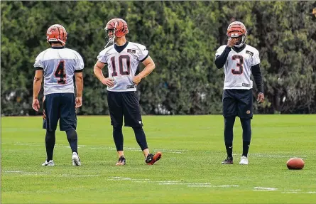  ?? NICK GRAHAM/STAFF ?? Bengals kickers Randy Bullock (from left), Kevin Huber and Jonathan Brown prepare for drills at practice in May. Brown hopes to line up for a field goal Thursday night when the Bengals host the Chicago Bears in their preseason opener at Paul Brown Stadium.
