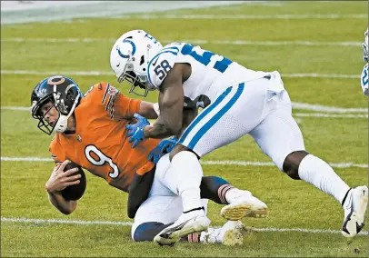  ?? PHOTOS BY CHARLES REX ARBOGAST/AP ?? Chicago Bears quarterbac­k Nick Foles (9) is tackled by Indianapol­is Colts' Bobby Okereke (58) during the first half.