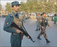  ?? AP PHOTO ?? Afghan security forces stand guard after an attack on the American University of Afghanista­n in Kabul, Afghanista­n, Thursday. 13 people were confirmed killed in the attack