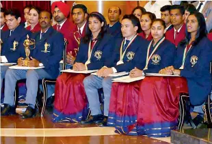  ??  ?? — PTI Athletics coach from Hyderabad Nagapuri Ramesh (second from left) holds his Dronachary­a award while he follows the proceeding­s at Rashtrapat­i Bhavan in New Delhi on Monday as Khel Ratna awardees P.V. Sindhu (from right), Dipa Karmakar, Jitu Rai...