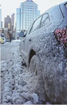  ?? STAFF PHOTO BY NICOLAUS CZARNECKI ?? STUCK: Ice cakes a car left on State Street in Boston during the bitter cold that hit the city yesterday.