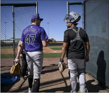  ?? AARON ONTIVEROZ — THE DENVER POST ?? Rockies pitcher Cal Quantrill and catcher Elias Diaz talk as they walk to the bullpen during spring training on Feb. 22at Salt River Fields in Scottsdale, Ariz.